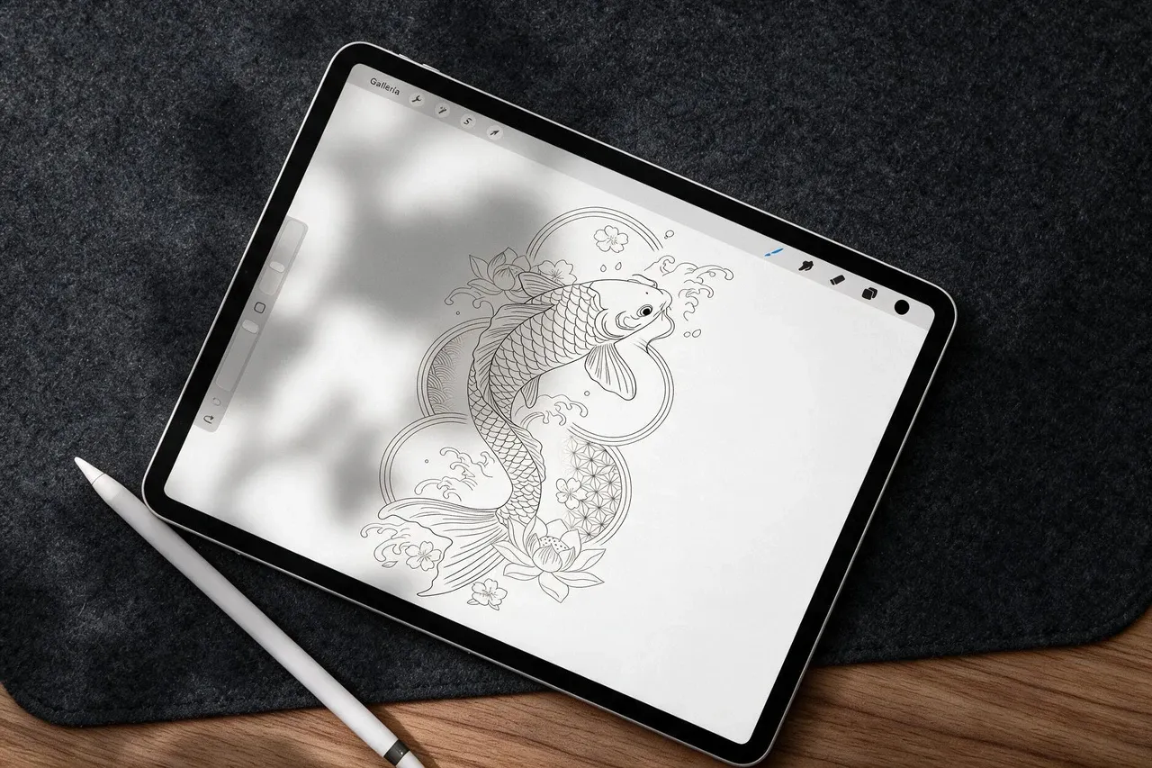 A koi tattoo design drawn in Procreate on an iPad, Apple Pencil alongside